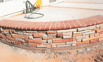 Custom brick masonry steps with bullnose edging matching a natural clay paver landing
