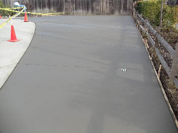 Uniform broom finish concrete driveway with clean expansion joints in Sacramento, CA