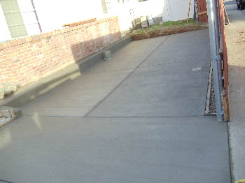 Reinforced concrete driveway installation with stamped border in Sacramento, CA.