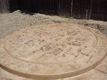 Custom stamped concrete patio with fire pit area installed by Delta Construction in Elk Grove, CA