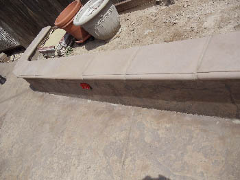 Engineered interlocking concrete block retaining wall for hillside erosion control