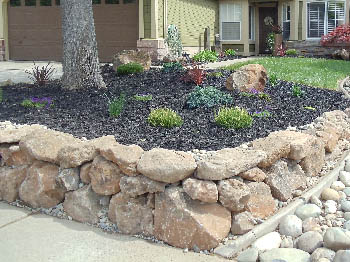 Engineered interlocking concrete block retaining wall for hillside erosion control