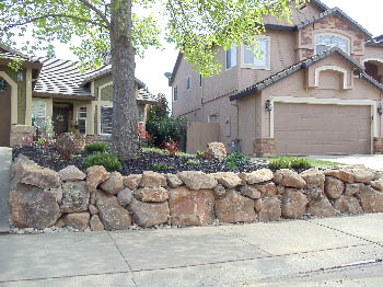 Engineered interlocking concrete block retaining wall for hillside erosion control