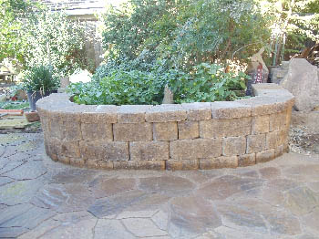 Engineered interlocking concrete block retaining wall for hillside erosion control