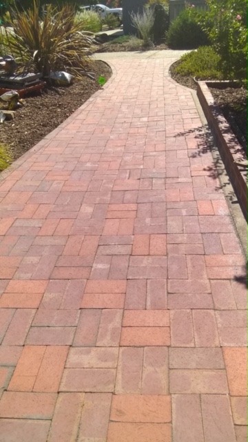 Curved stamped concrete walkway with charcoal border in Elk Grove, CA