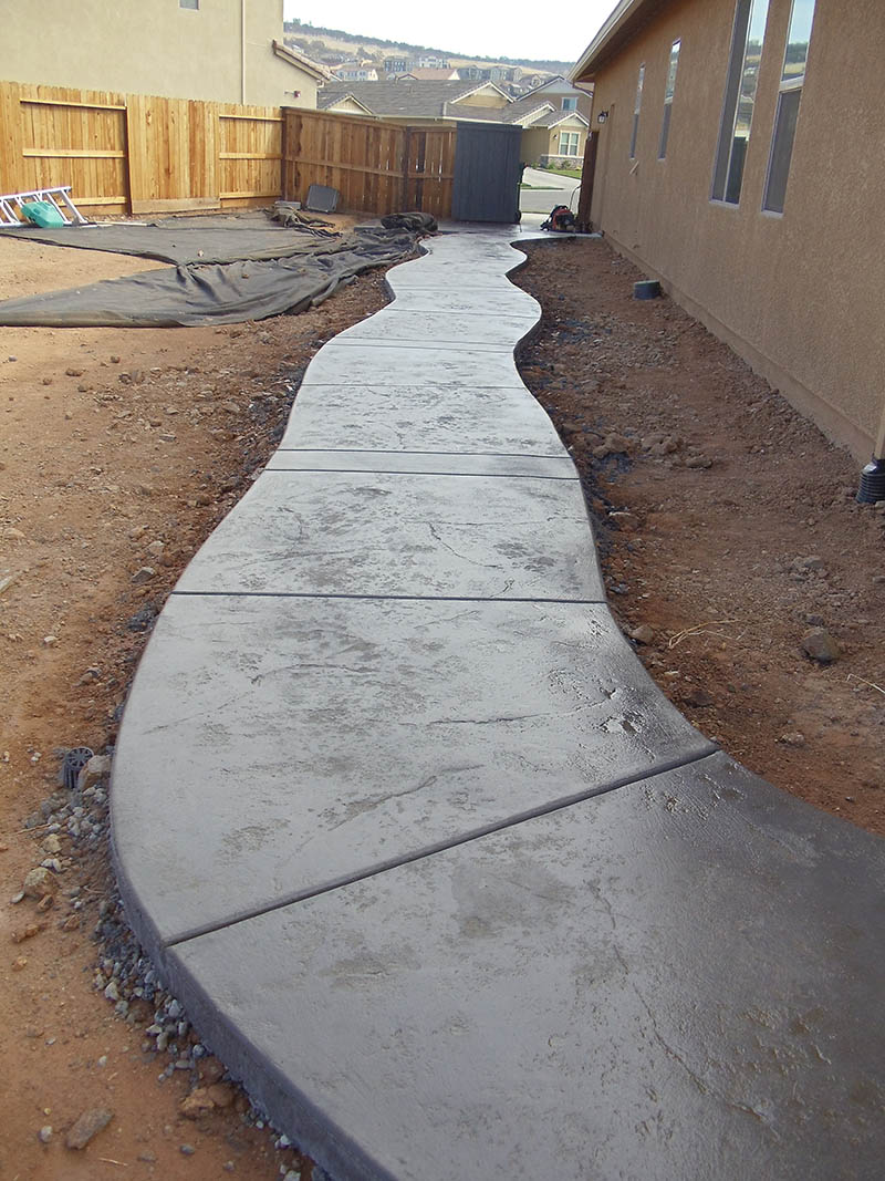 Curved stamped concrete walkway with charcoal border in Elk Grove, CA