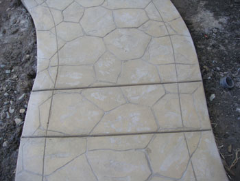 Curved stamped concrete walkway with charcoal border in Elk Grove, CA