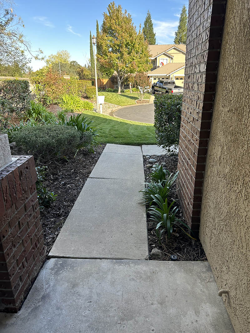 Curved stamped concrete walkway with charcoal border in Elk Grove, CA