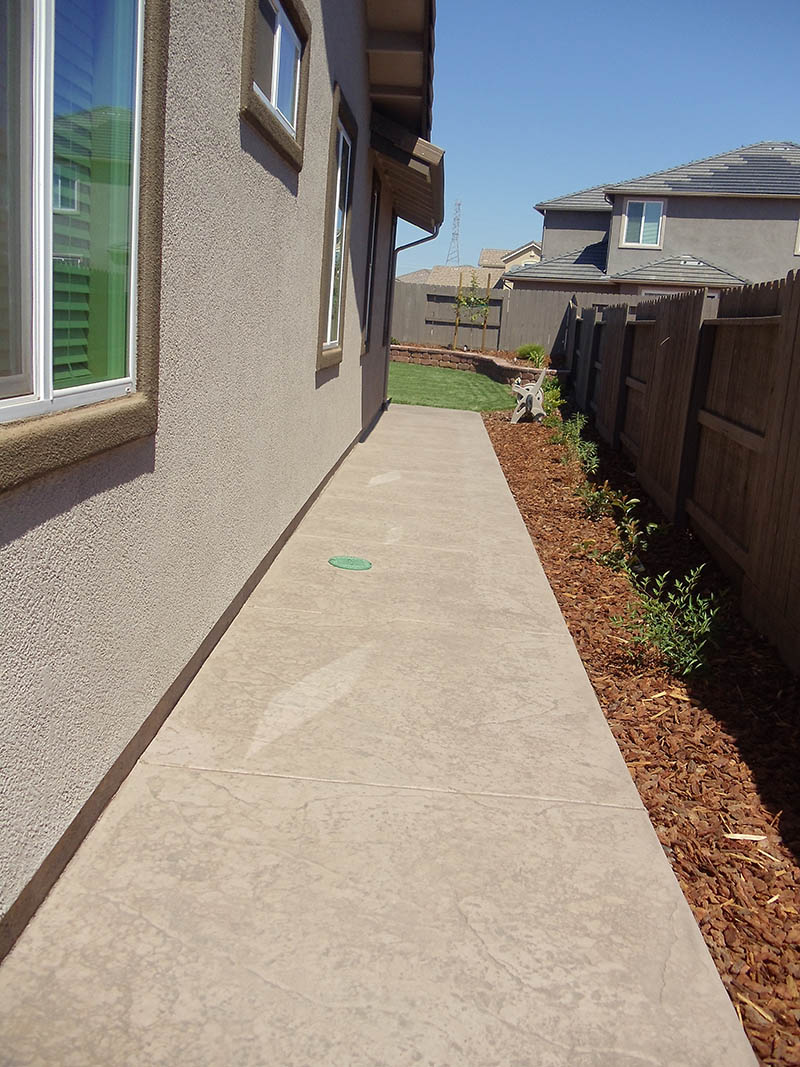 Curved stamped concrete walkway with charcoal border in Elk Grove, CA