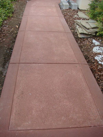 Curved stamped concrete walkway with charcoal border in Elk Grove, CA